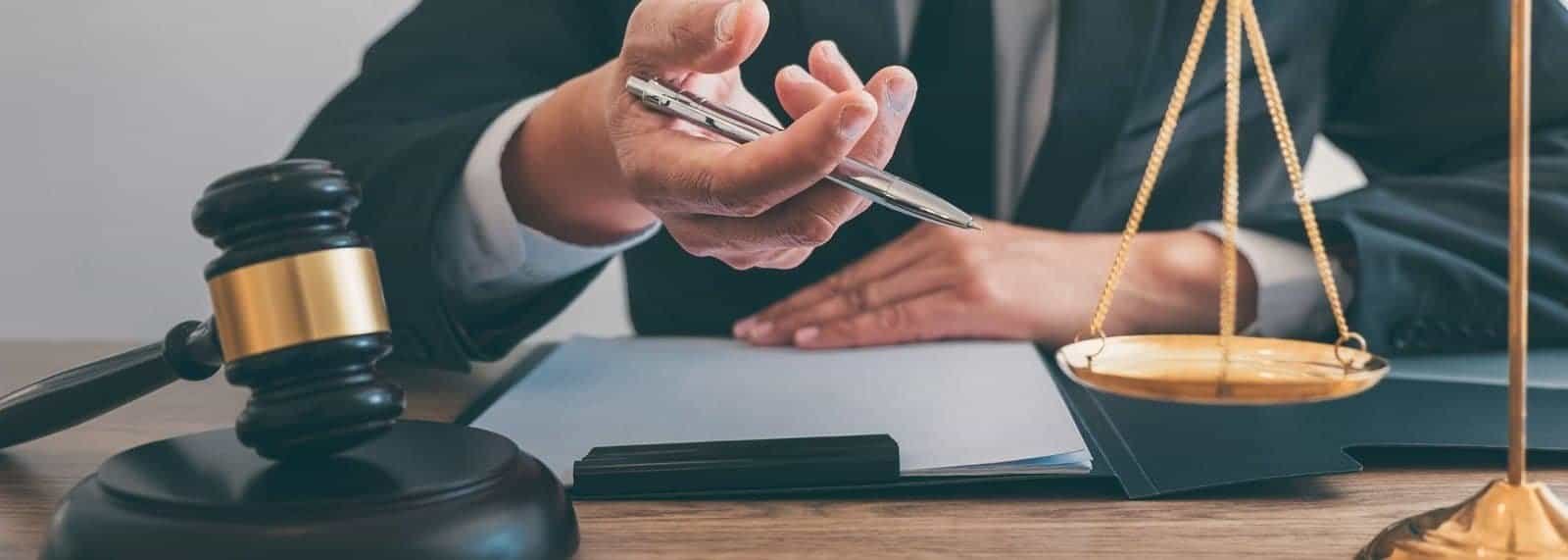 a person holding a pen over a document